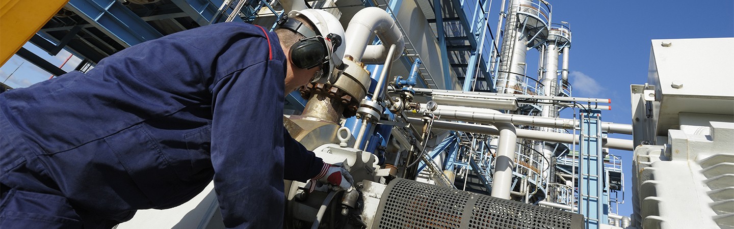 Technician servicing petrochemical plant equipment